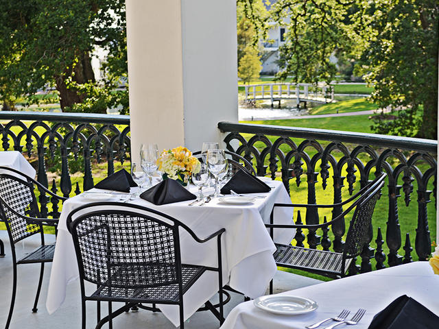 Mansion balcony dining offers a sweeping view of the grounds