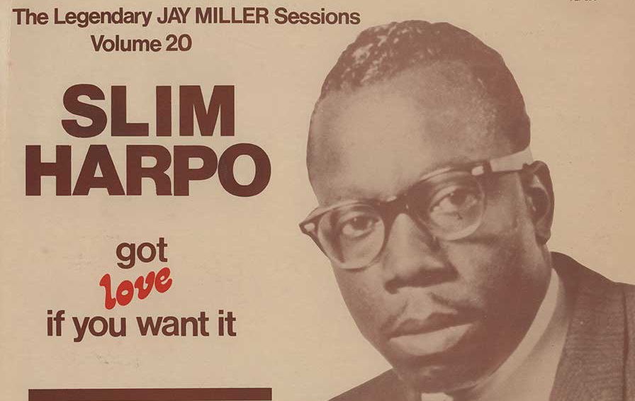 A sepia-toned album cover of Slim Harpo's "Got love if you want it." Slim, wearing black Ray Bans, looks toward the camera, wearing a dark suit and tie.