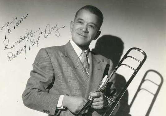 A signed portrait of Kid Ory holding a trombone
