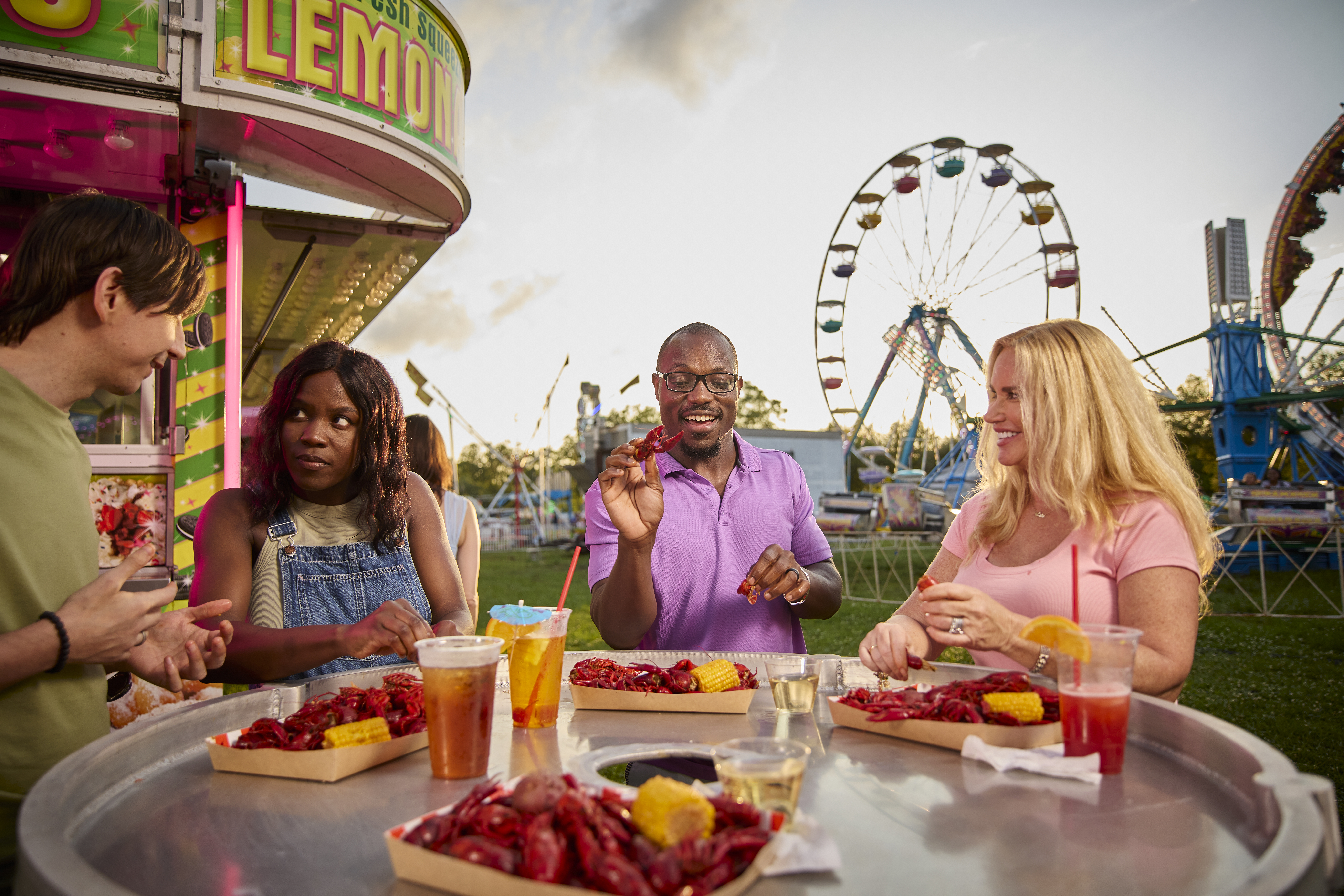 Four patrons eat crawfish and drink beer in Breaux Bridge.