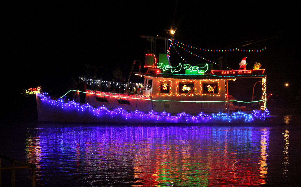 A boat is lit with Christmas lights