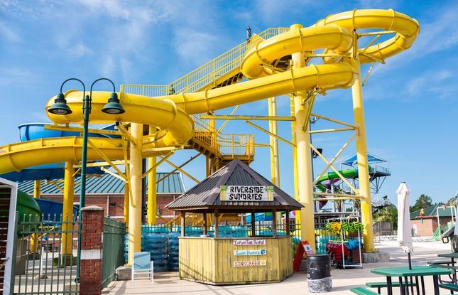The Riverside Sundries shop at SPAR Waterpark in front of a massive tube slide in Lake Charles.