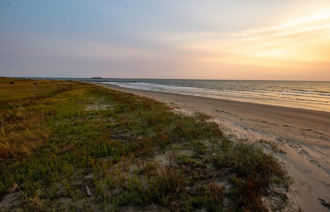 A stunning sunset view from the beach at Grand Isle State Park.