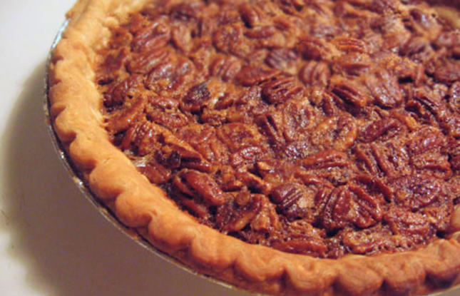 Pecan pie, with a filling dotted with Louisiana pecans, surrounded by a flaky golden crust.