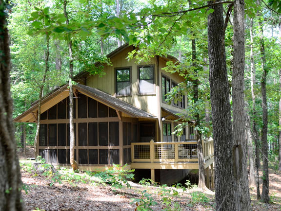 A wooden cabin in the woods of Lake Claiborne State Park.