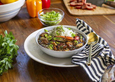 Bowl of Louisiana Seafood Gumbo surrounded by gumbo ingredients