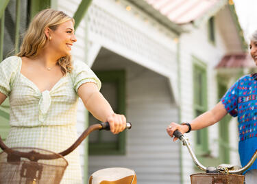Two people bike in downtown St. Francisville.