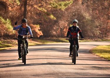 Two people biking a paved trail