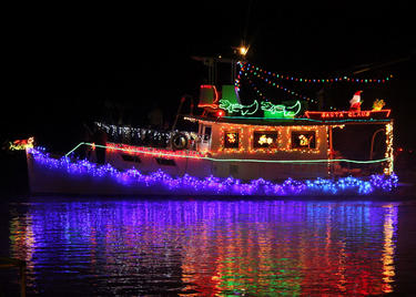 A boat is lit with Christmas lights