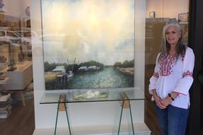 Kathy Biedenharn, Owner I Levee Gallery with Dr. Charles Guess Painting Photo