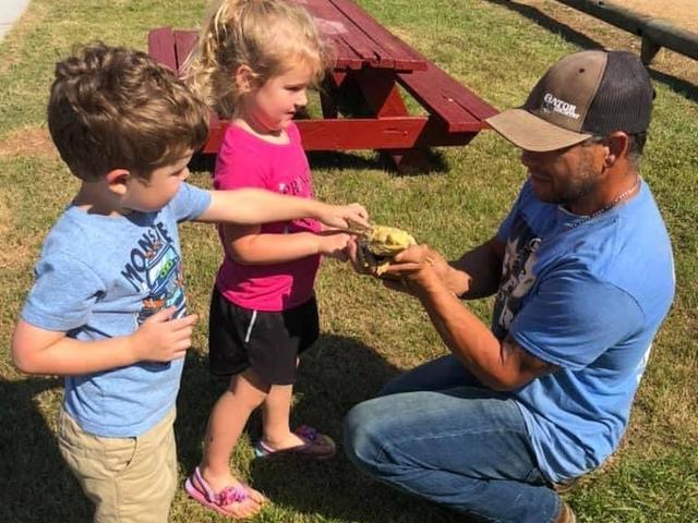 Kids petting a lizard