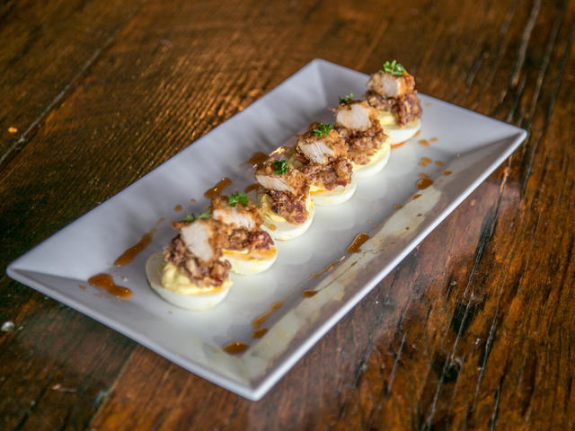"Which Came First" Deviled eggs topped with fried chicken, bacon jam and sweet chili sauce