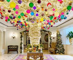 Ritz Carlton New Orleans Holiday Hotel Display, featuring brightly colored ornaments hanging from the ceiling.