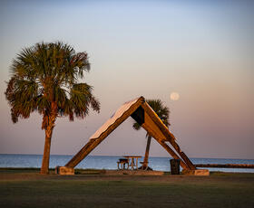 A picnic pavilion during sunset at Cypremort Point State Park.