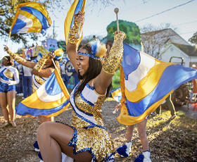 Flag twirler in Krewe of Kings parade