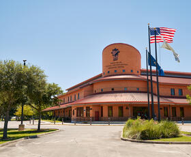 The exterior of the Tunica-Biloxi Museum, a clay-colored round building in Marksville, Louisiana.