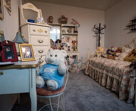 Replica of Britney Spears' bedroom at Kentwood Museum, with teddy bears and toys on the bed and strewn throughout the room.