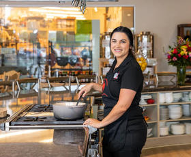 A person stirs the contents of a pot.