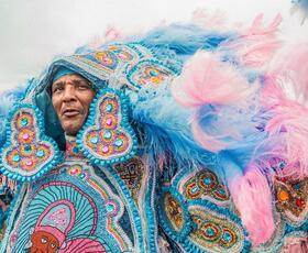 A Mardi Gras Indian wears a beautiful, elaborate blue costume at Jazz Fest.