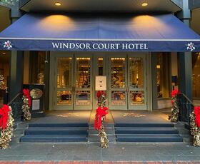 The Windsor Court's exterior features holiday trees.