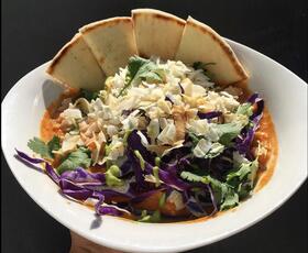 A veggie-forward dish with pita bread triangles on the side from MJ's Cafe