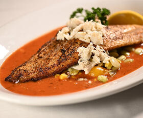 An authentic Creole dish with fish and a tomato-based sauce waits to be served at Dooky Chase's Restaurant in New Orleans.
