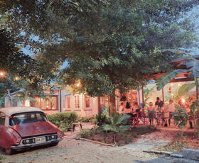 A red, vintage Citroen decorates the lawn outside the terrace of N7 in New Orleans.