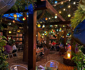 Strings of lanterns glow overhead on the outside terrace at Velvet Cactus in New Orleans.