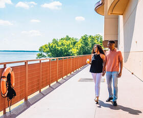 A couple walks by the Red River.