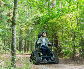 A person explores a Louisiana State Park using a mobility aid.