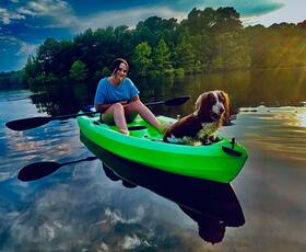 A kayaker and their dog pose on a lake in Toledo Bend.