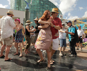 Couples dance to live music at the French Quarter Festival in New Orleans.
