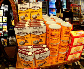A colorful display of Cafe Du Monde beignet mix, coffee with chicory and creamy pralines.