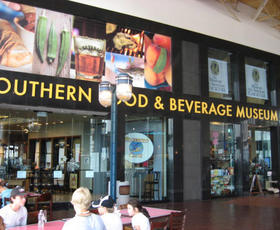 The exterior of the Southern Food &amp; Beverage Museum, as photographed from inside the Dryades Market, with a lamppost obstructing part of the view.
