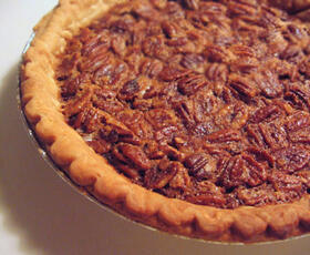 Pecan pie, with a filling dotted with Louisiana pecans, surrounded by a flaky golden crust.