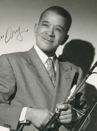A signed portrait of Kid Ory holding a trombone