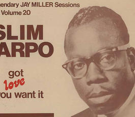 A sepia-toned album cover of Slim Harpo's "Got love if you want it." Slim, wearing black Ray Bans, looks toward the camera, wearing a dark suit and tie.
