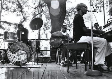 Professor Longhair sits at a piano on stage with his dreamy and bass player