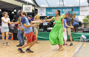 A couple dances at the jazz stage during the French Quarter Fest in New Orleans.