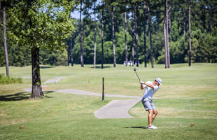 Male golfer golfing on a Louisiana golf course.