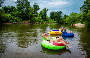 People float down the Bogue Chitto River in tubes.
