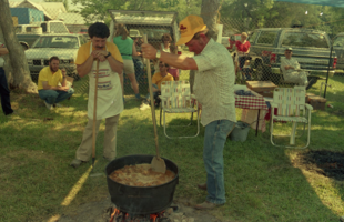 A team of cooks stir a giant pot of jambalaya in the 1986 Jambalaya Festival in Gonzales, Louisiana.